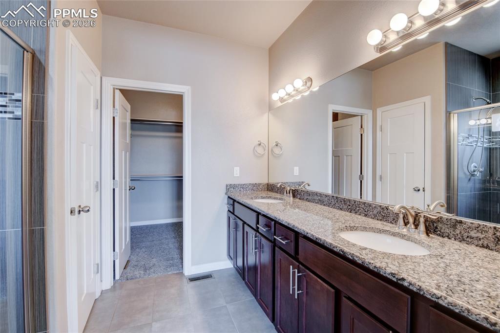 Image 17 of 36: Bathroom featuring a dual vanity with granite countertops, undermount sinks