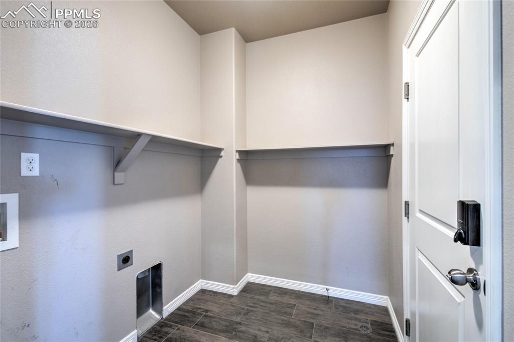 Image 23 of 36: Utility room featuring tiled flooring, a white door with dark hardware, and
