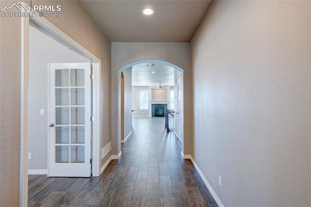 Image 4 of 36: Inviting entryway featuring wood-look tile flooring, an arched doorway, and