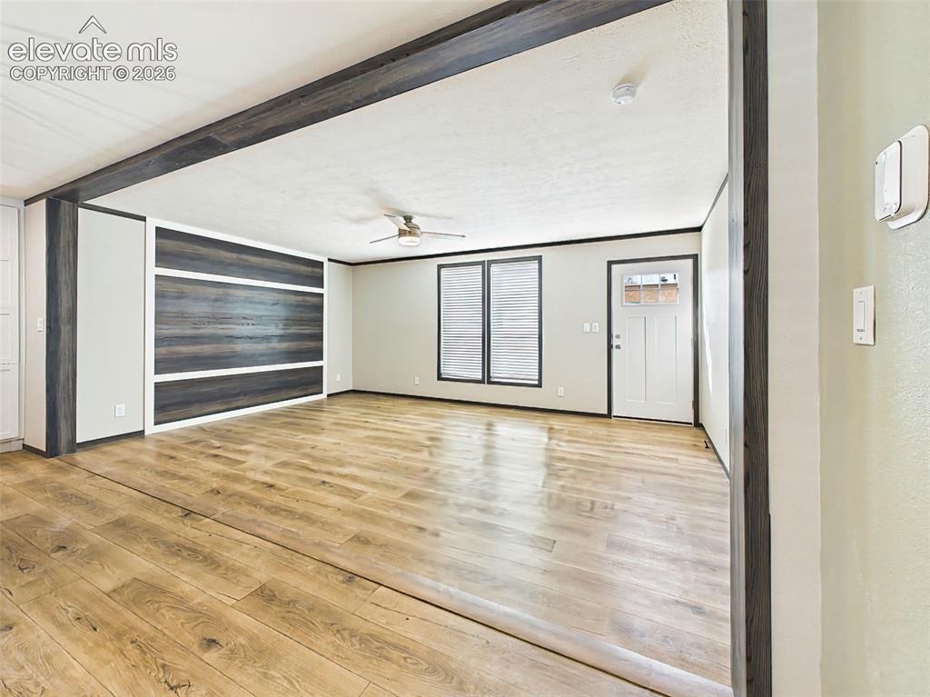 Image 13 of 50: Living Room – Bright, open living area showcasing the custom accent wall, a