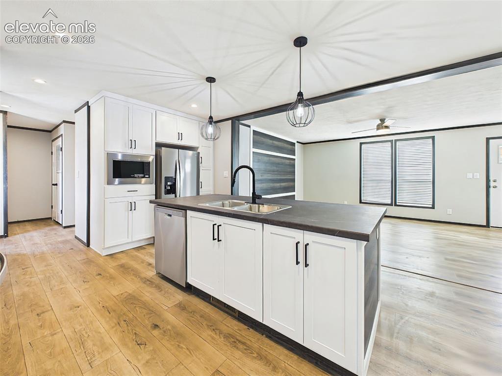 Image 15 of 50: Kitchen – Oversized center island with an island sink, breakfast bar seatin