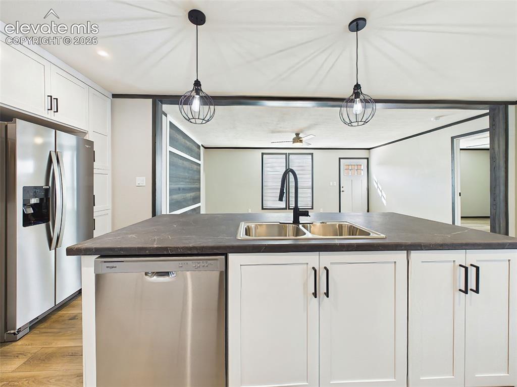 Image 23 of 50: Kitchen – Expansive center island with an island sink, breakfast bar seatin