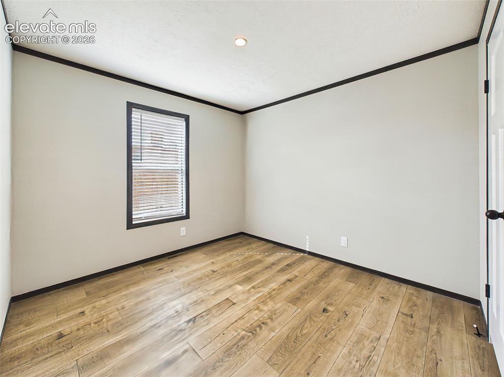 Image 43 of 50: Bedroom 4– Clean, move-in ready secondary bedroom featuring wood-style floo