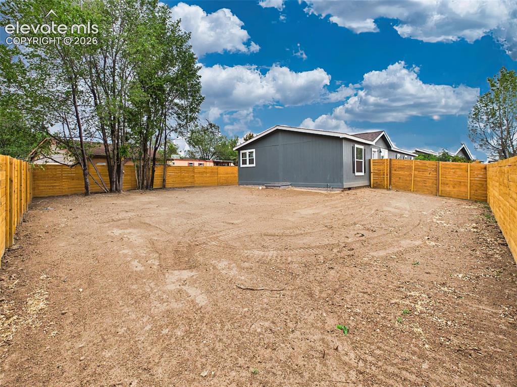Image 48 of 50: Backyard – Expansive backyard with privacy fencing provides a blank canvas 