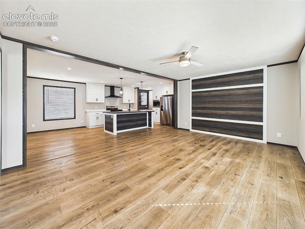 Image 5 of 50: Great Room – Expansive living area with a custom accent wall, abundant natu