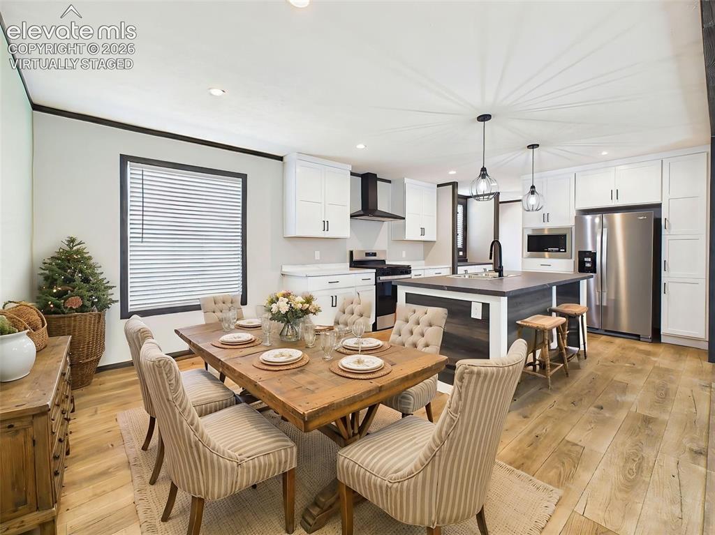 Image 8 of 50: (Virtually Staged) Dining Area & Kitchen – Dining space flows effortlessly 