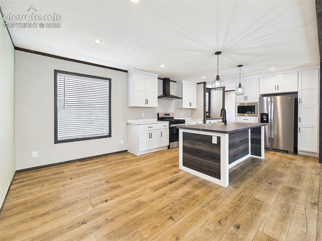 Image 9 of 50: Kitchen & Dining Area – Spacious eat-in kitchen with a large center island,