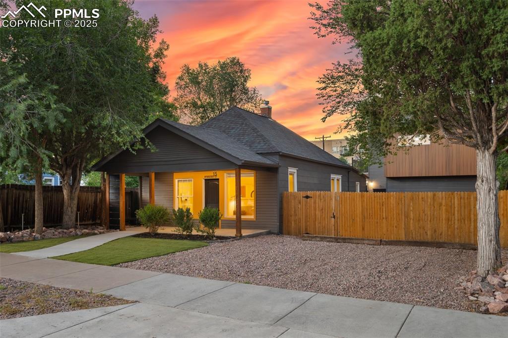 Image 2 of 38: View of front facade featuring a chimney and roof with shingles