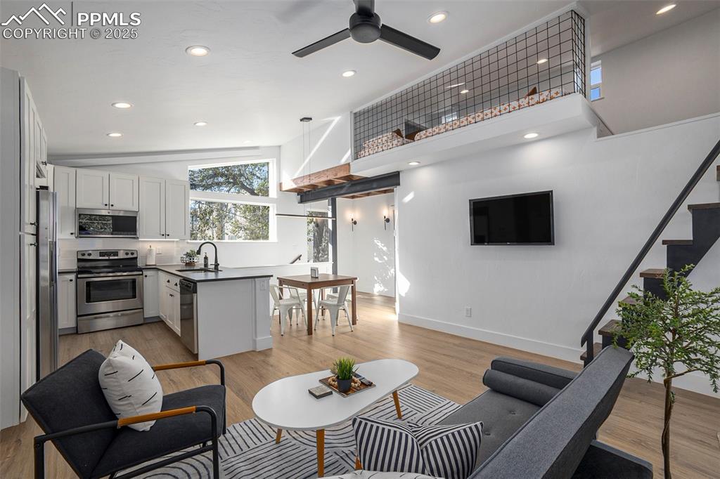 Image 22 of 38: Living room with recessed lighting, lofted ceiling, light wood-style floori