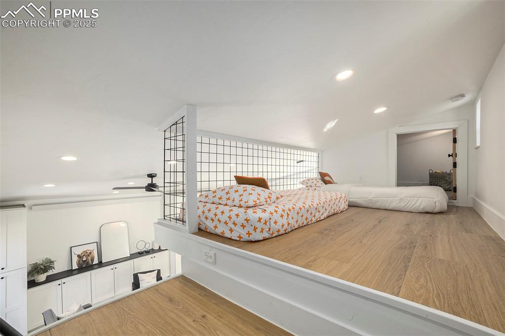 Image 29 of 38: Bedroom featuring recessed lighting, light wood-style floors, and lofted ce