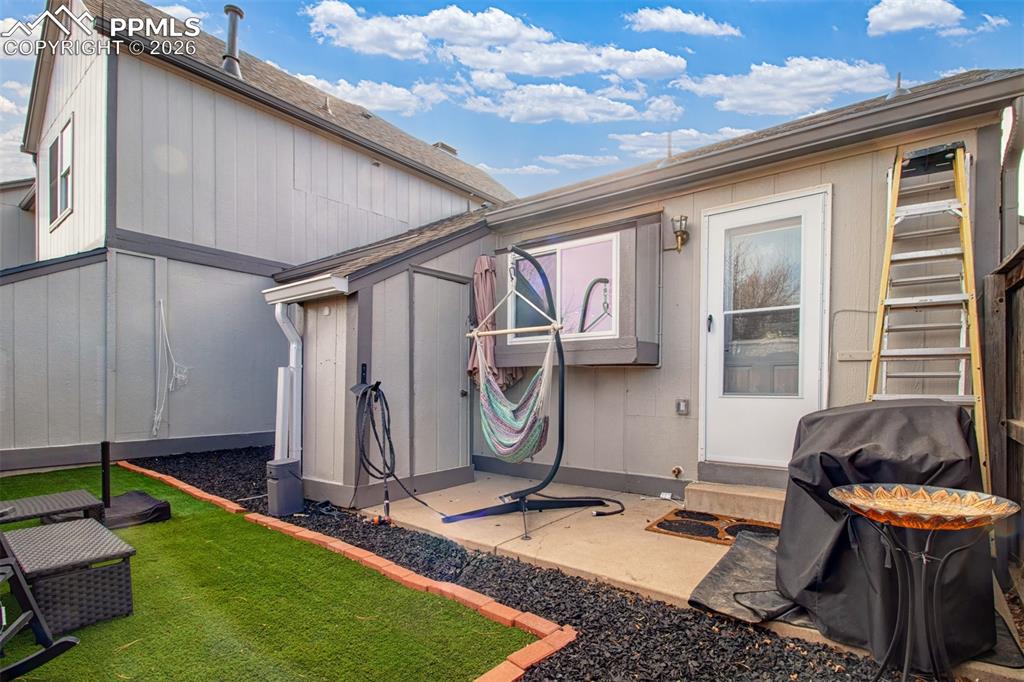 Image 16 of 17: Rear of home with additional storage space. 