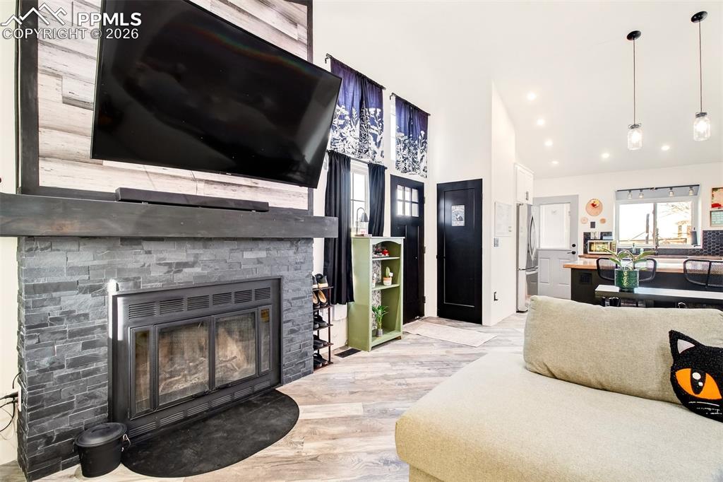 Image 5 of 17: Wood burning fireplace with updated modern front.