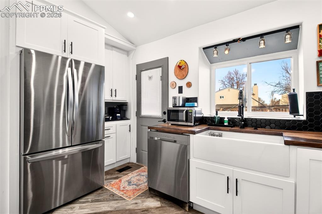 Image 7 of 17: Stainless steel appliances, garden window and a stylish coffee bar area.