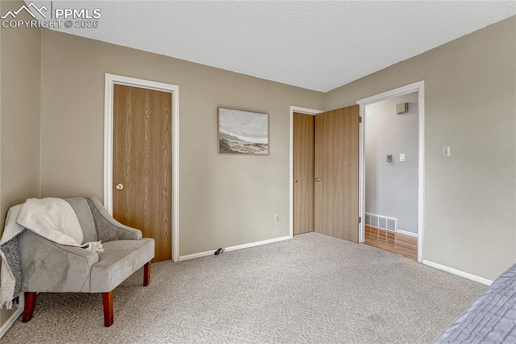 Image 20 of 49: Primary bedroom with door to full bathroom and walk in closet