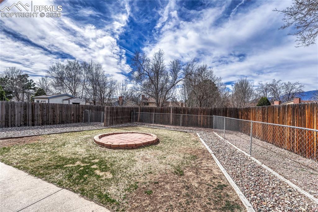 Image 36 of 49: Fully fenced yard with dog run