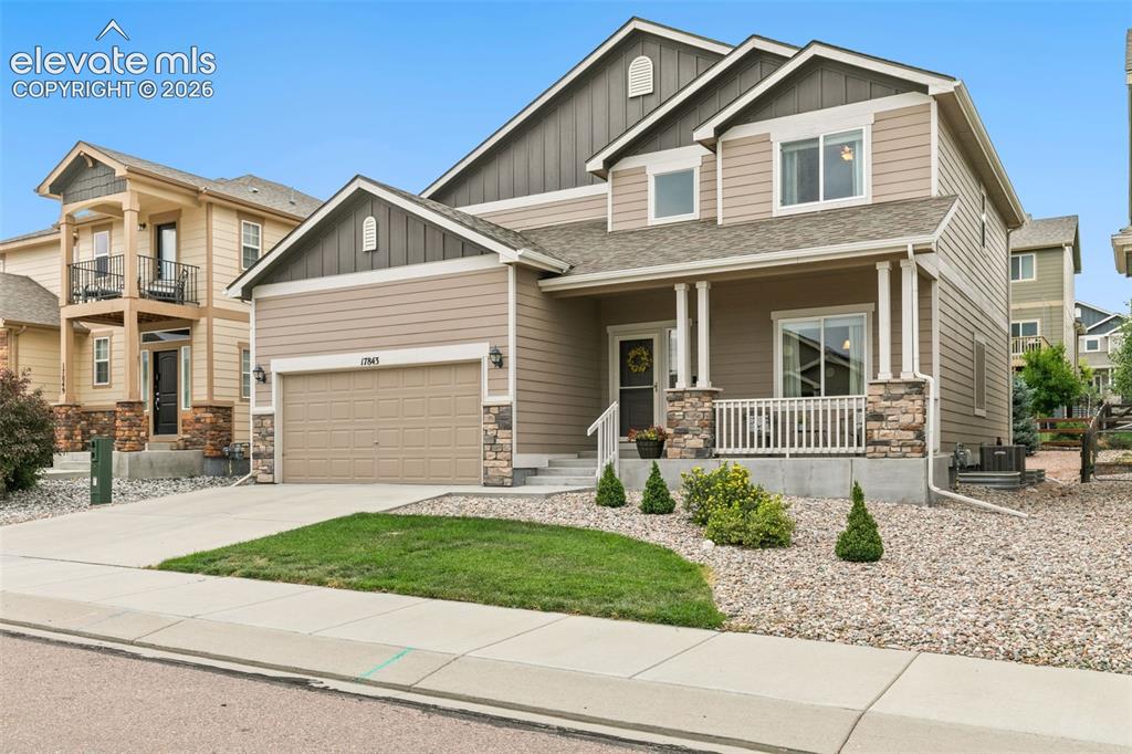 Caption: Front of home, with low maintenace landscaping a welcoming front porch