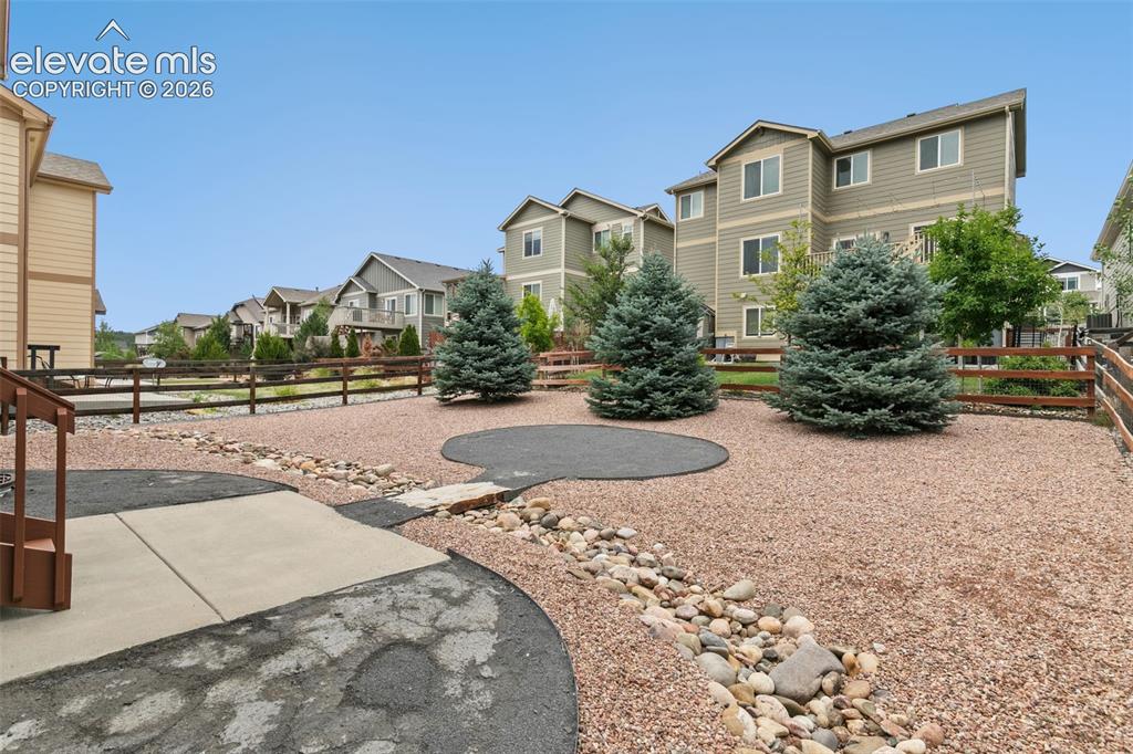 Image 23 of 27: Xeroscaped back yard with spot for firepit or patio set