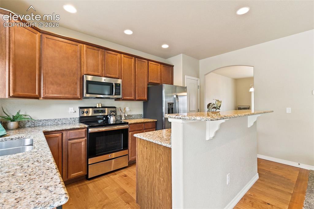 Image 8 of 27: Kitchen featuring stainless appliances and granite countertops