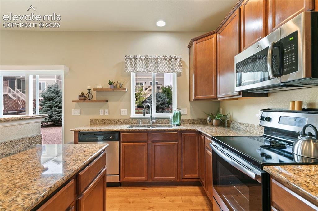 Image 9 of 27: Kitchen featuring stainless appliances and granite countertops