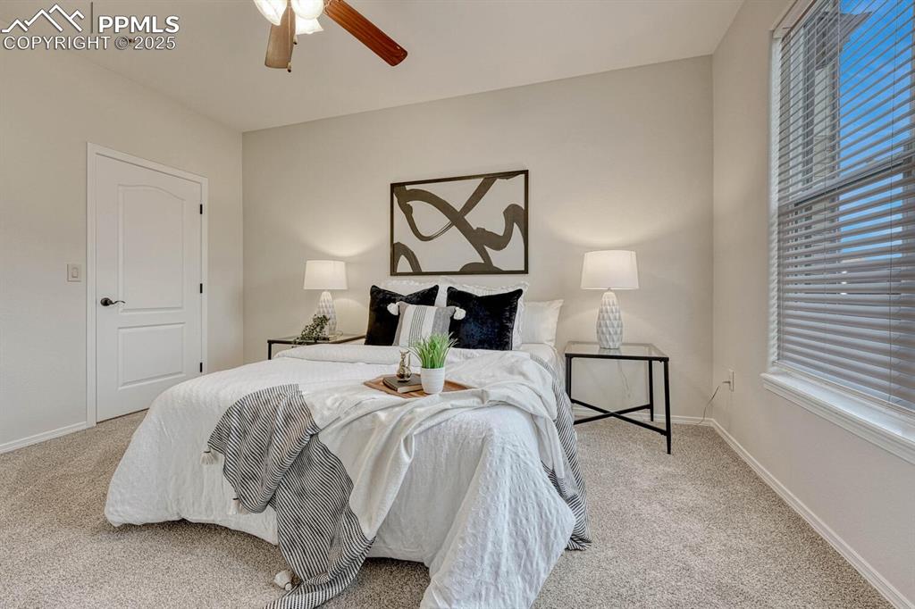 Image 19 of 27: Bedroom featuring a ceiling fan and light colored carpet