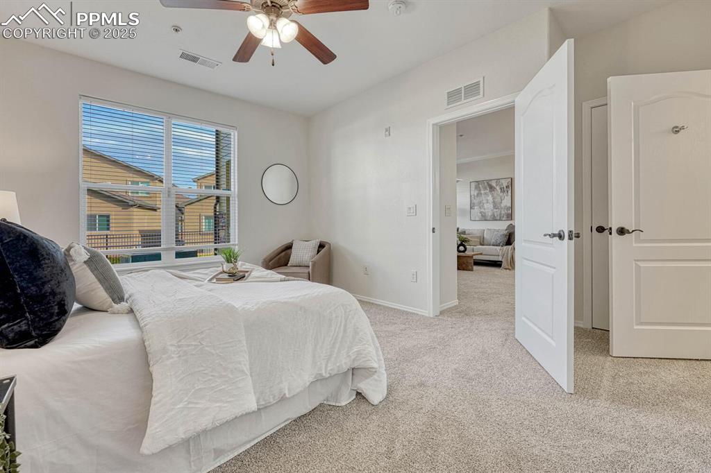 Image 20 of 27: Bedroom with carpet flooring and a ceiling fan