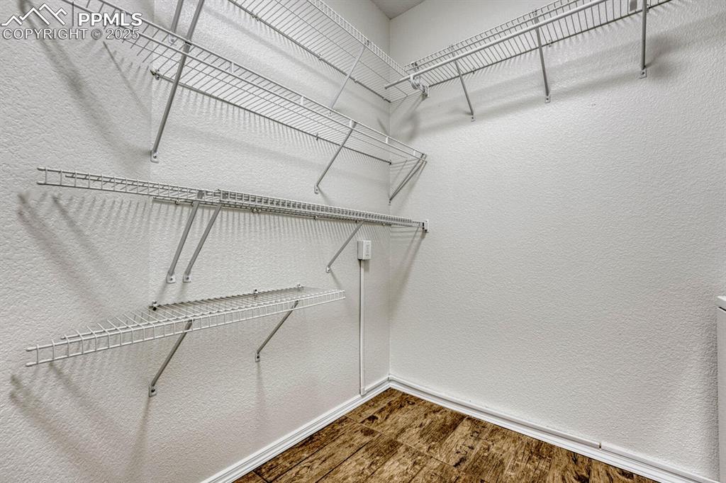 Image 24 of 27: Spacious laundry room with ample storage/shelving
