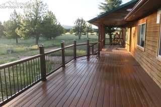 Image 26 of 36: View of new wrap-around deck with built-in solar lighting