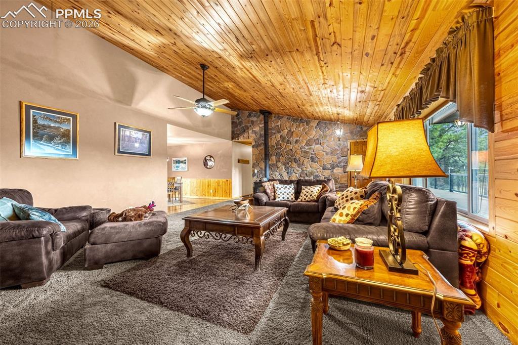 Image 4 of 36: Carpeted living room with wood ceiling, a ceiling fan, lofted ceiling, and 