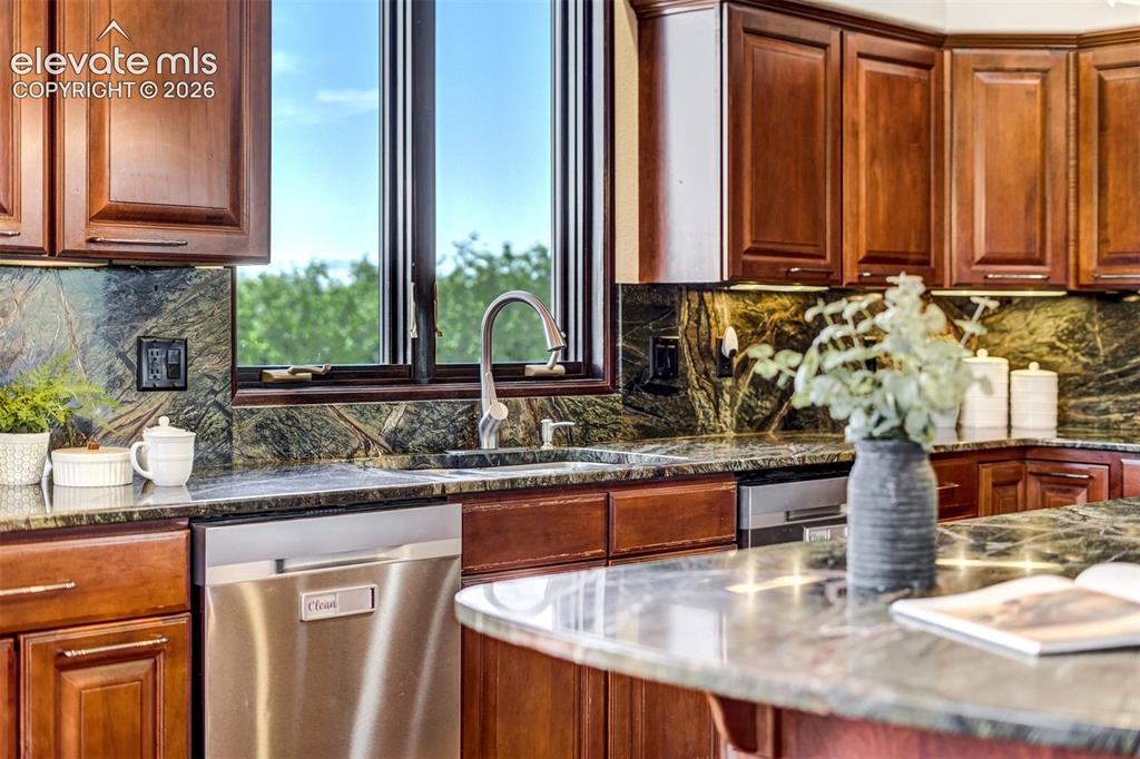 Image 17 of 50: Three prep sinks, two dishwashers, and enough space for family members to c