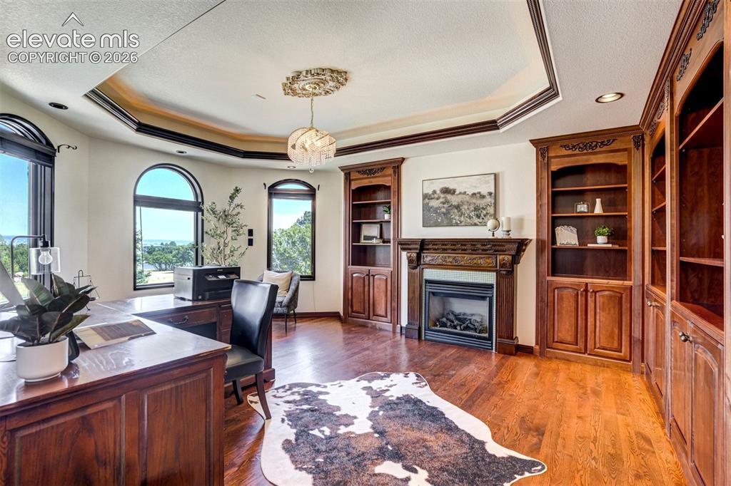 Image 25 of 50: Main level office with handcrafted woodwork that deserves the spotlight.