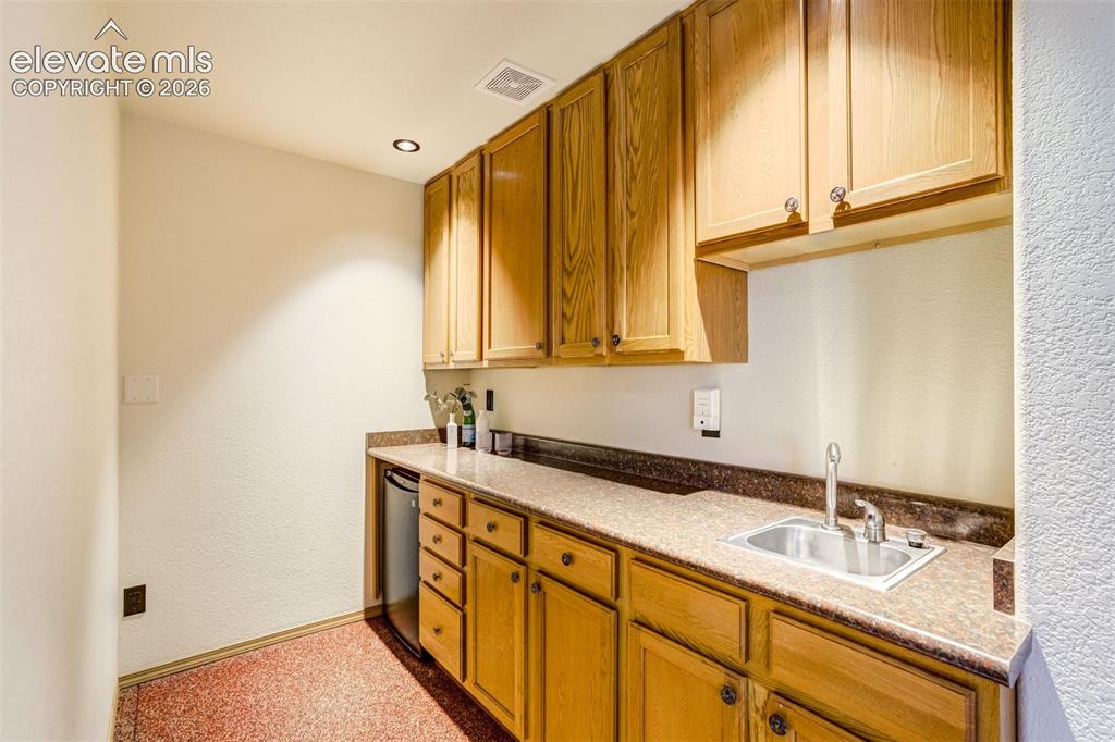 Image 42 of 50: Wet bar in the basement.