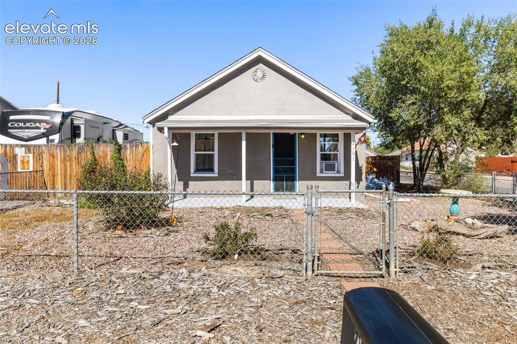 Image 1 of 23: Gabled stucco exterior with a covered porch, white window trim, and a chain