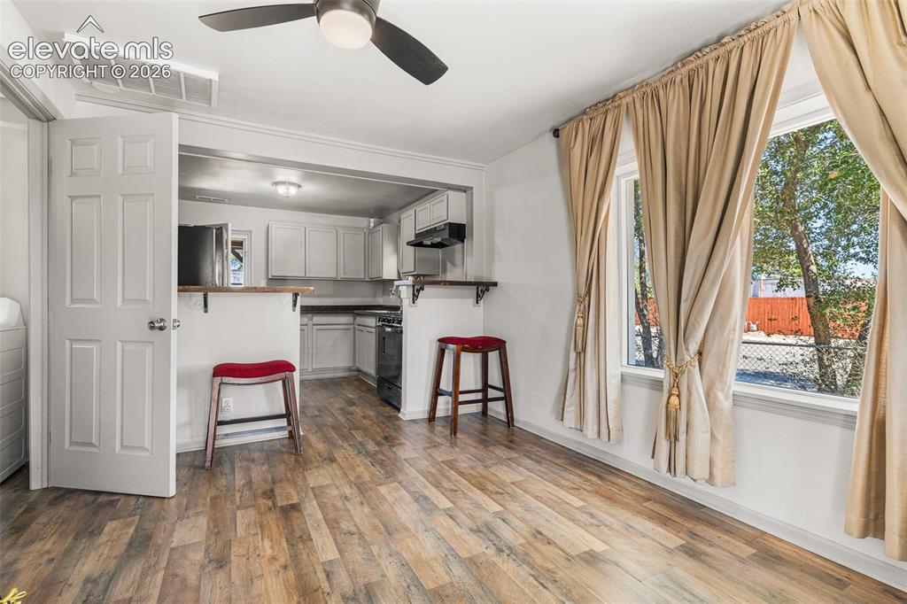Image 5 of 23: Wood-finish flooring throughout, with a ceiling fan light fixture and reces