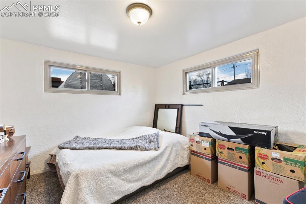 Image 13 of 49: Carpeted bedroom featuring a textured wall