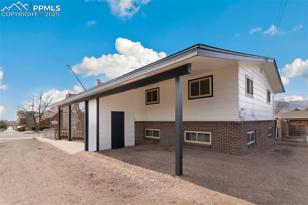 Image 2 of 49: Rear view of house featuring fence