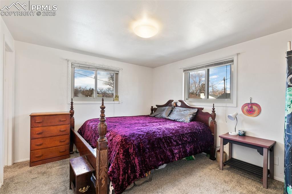 Image 21 of 49: Bedroom featuring baseboards and carpet floors