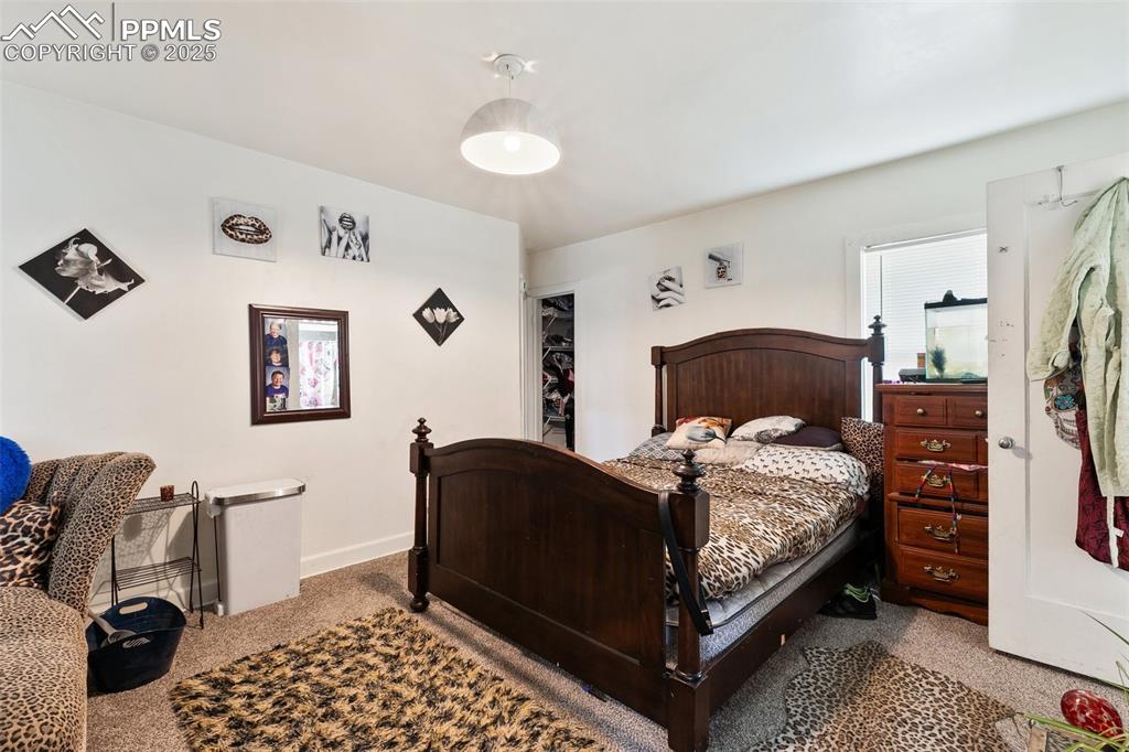 Image 36 of 49: Carpeted bedroom featuring baseboards