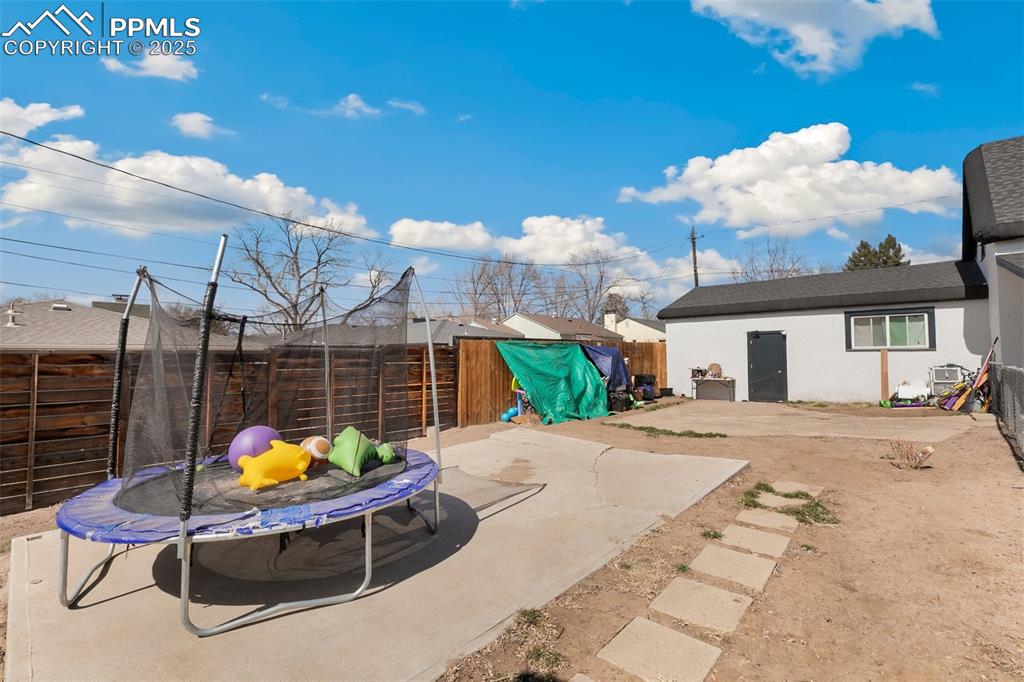 Image 48 of 49: View of patio / terrace featuring a fenced backyard and a trampoline