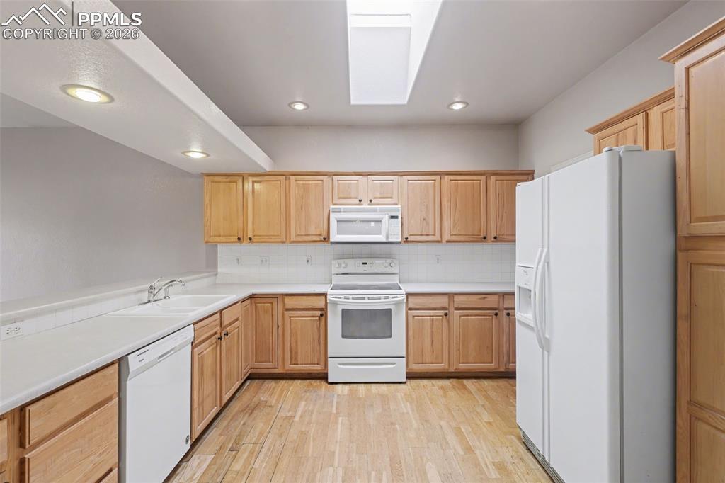 Image 11 of 28: Spare room featuring light wood finished floors and suspended lighting