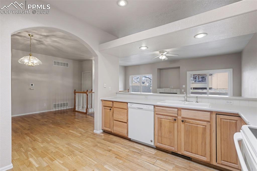 Image 13 of 28: Kitchen featuring white appliances, light countertops, tasteful backsplash,