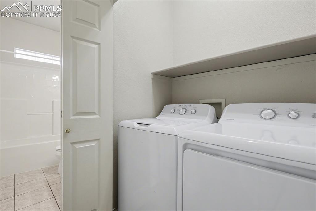 Image 14 of 28: Kitchen with light countertops, stove, dishwasher, light wood-style floors,