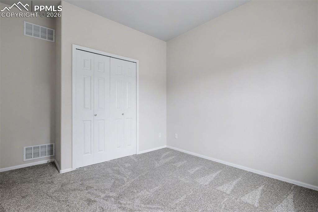 Image 15 of 28: Laundry area featuring washing machine and dryer and light tile patterned f