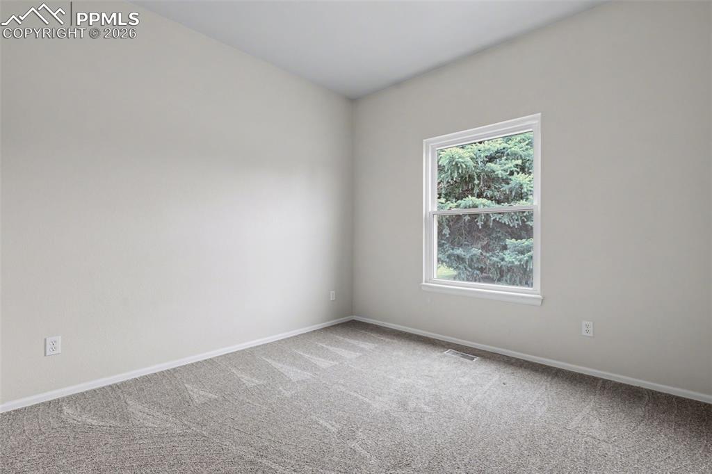 Image 16 of 28: Unfurnished bedroom with carpet and a closet