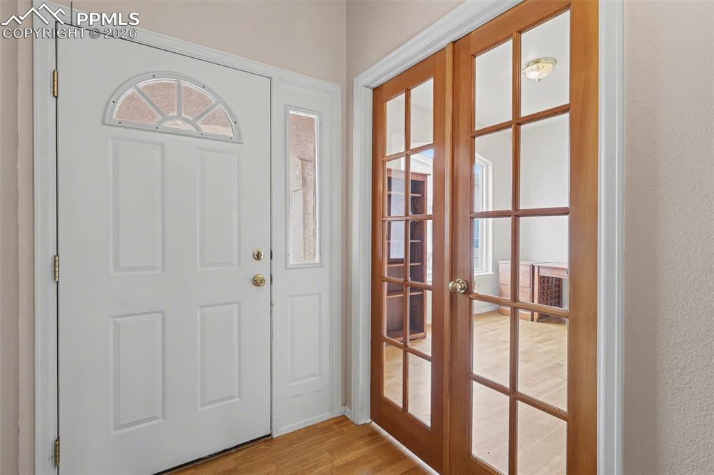Image 3 of 28: Obstructed view of property featuring stucco siding, an attached garage, dr