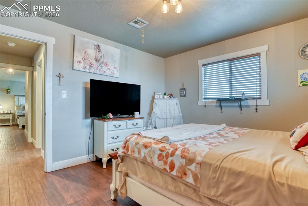 Image 20 of 50: Bedroom with baseboards and wood finished floors