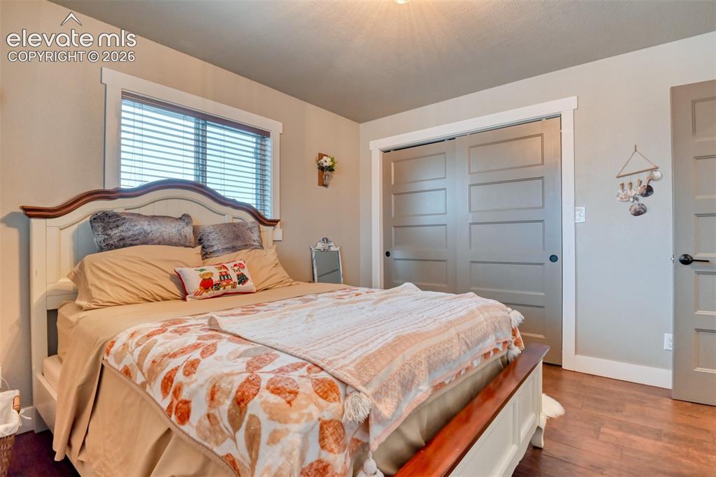 Image 22 of 50: Bedroom with a closet and dark wood finished floors