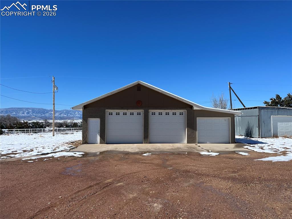 Image 46 of 50: View of front of home featuring an outdoor structure and a garage