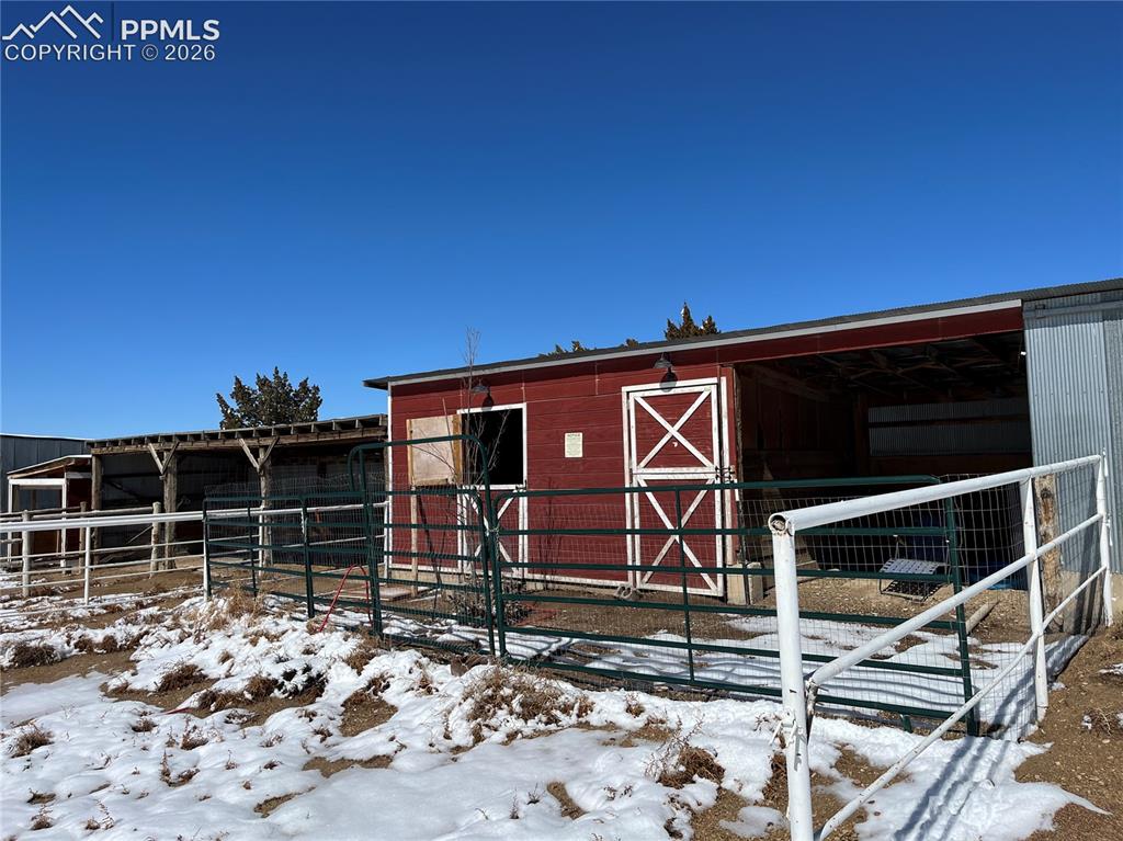 Image 48 of 50: Snow covered structure featuring an exterior structure
