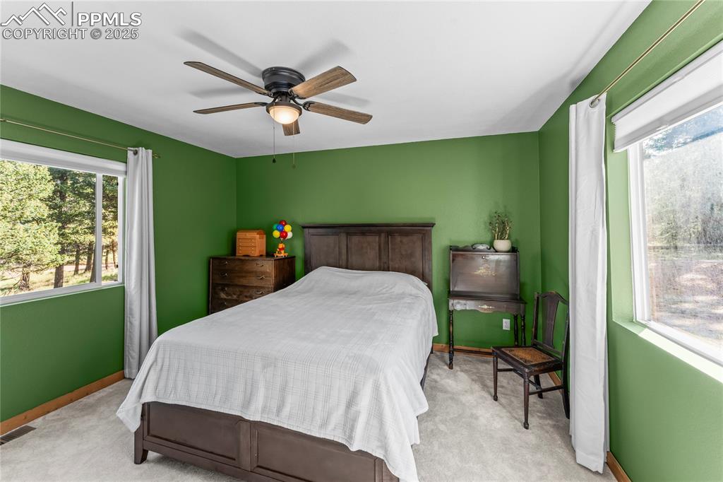 Image 19 of 39: Carpeted bedroom featuring baseboards and ceiling fan