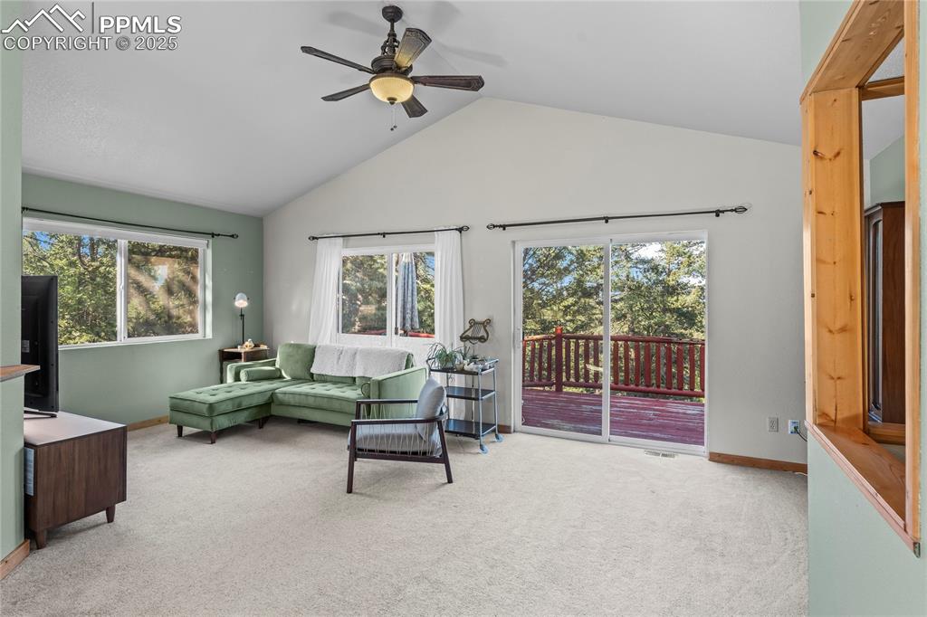 Image 8 of 39: Living room with dual sliding doors to back deck